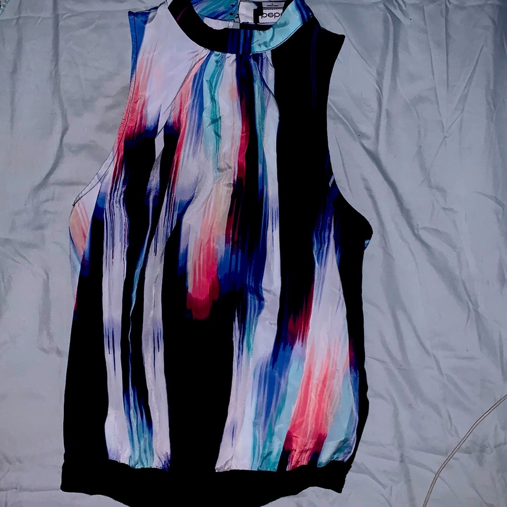 Bebe medium sleeveless pin up top. Colors are red white and blues.